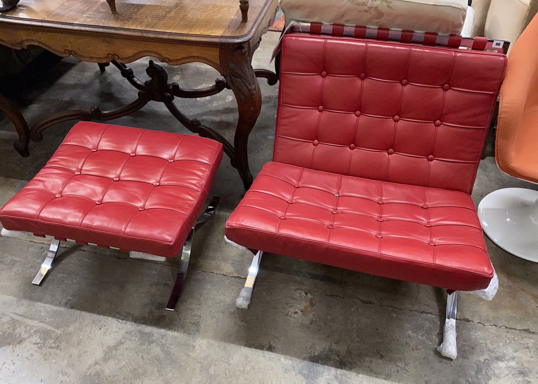 A Knoll Studio Barcelona style red leather and chrome chair, width 75cm, depth 75cm, height 74cm and footstool